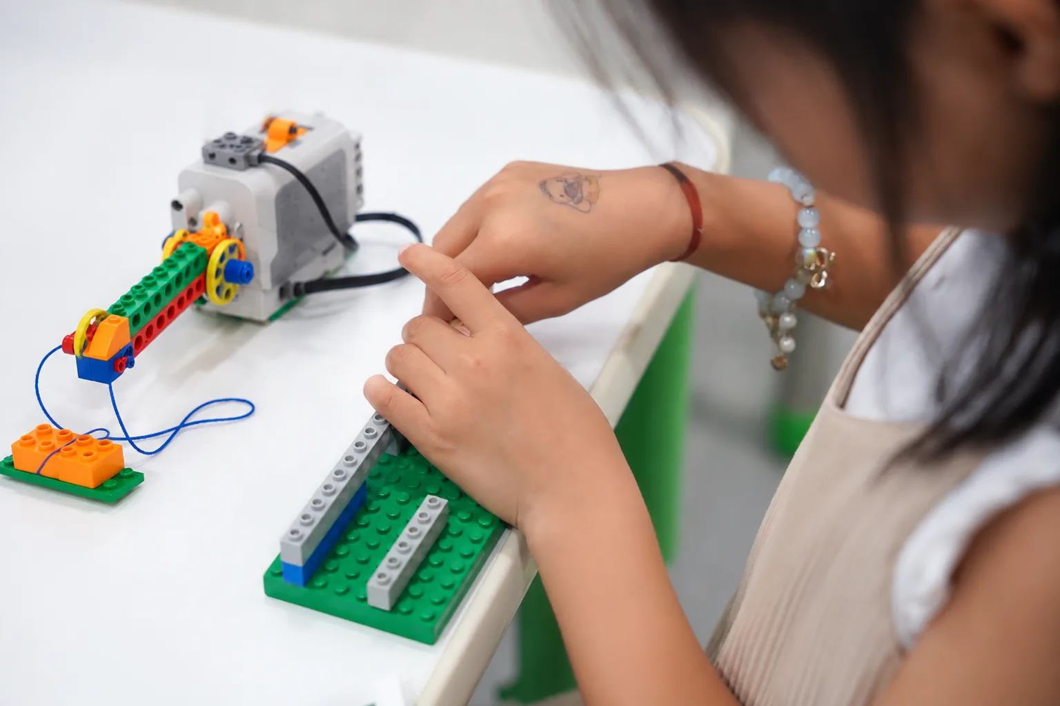 Adapter student developing hand and finger coordination through building