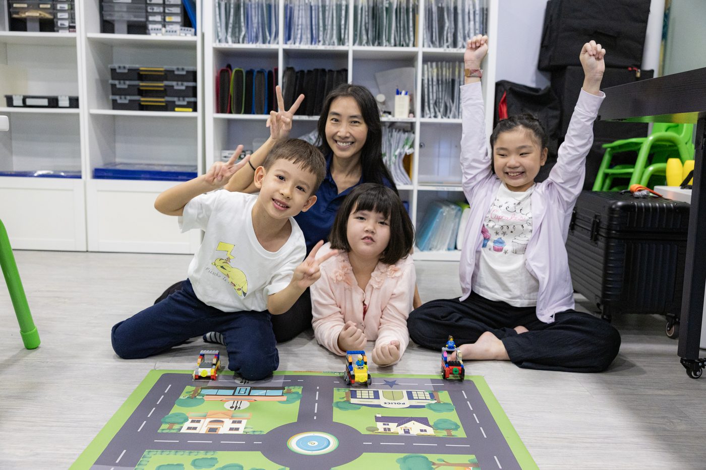 Meta Robotics students and instructor celebrating after a build-and-race challenge