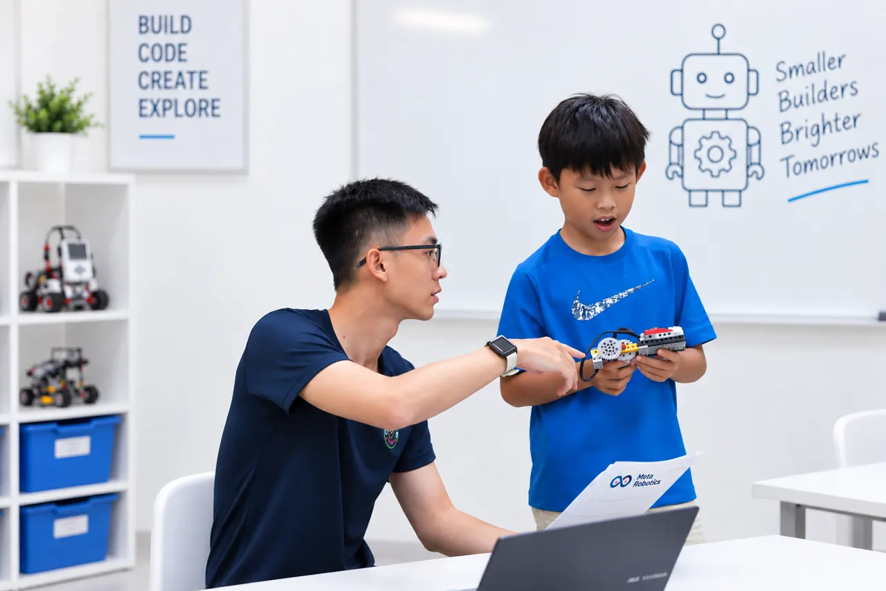 Coach guiding a child through a robotics discovery activity